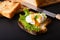 Organic Food breakfast concept homemade Poached egg or eggs benedict on sourdough bread toasted on black slate board
