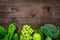 Organic food for homemade salad with green vegetables on wooden desk background top view mockup