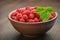 Organic food of red raspberries, wooden oak table