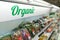 Organic food signage on modern supermarket fresh produce vegetable aisle