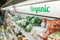 Organic food signage on modern supermarket fresh produce vegetable aisle