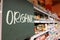 Organic food signage on modern supermarket grocery aisle