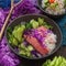 Organic food: tuna poke bowl with rice, fresh cucumbers, red cabbage and avocado close-up. Generative. AI.