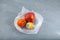 Organic food waste. Rotten fruits pomegranate, persimmon, orange in plastic bag. Concept - Imperfect storage vegetables and