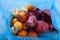 Organic food waste. Rotten fruits pomegranate, persimmon, orange in trash can. Imperfect storage vegetables and fruits