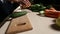 Organic fresh cucumber on wooden chopping board.