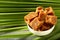 Organic fresh jaggery cubes on palm tree leaf