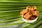 Organic fresh jaggery cubes on palm tree leaf