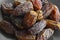Organic fresh nutritious dried hurma dates medjool grains, in gray plate