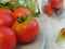 Organic fresh tomatoes from home garden on a plate. Herbs and horseradish.