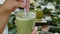 Organic Freshly Squeezed Green Vegetable and Fruit smoothie Into the Glass