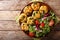 Organic fried meatballs with spinach and vegetable salad close-up. horizontal top view