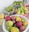 Organic garden products, all natural apples, pears, tomatoes, standing in large bowls on the balcony of a house