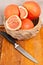 Organic grapefruits in a basket and knife