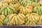 Organic green and natural ripening banana bunches at fruit stand in Geylang, Singapore