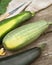 Organic, green zucchini with textile napkin on a wooden table