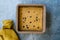 Organic Healthy Raw Oat Cake Slices with Banana and Chocolate Chips in Square Cake Mold