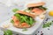 Organic healthy sandwiches with salmon and bagel, cream cheese and wild rocket and lemon