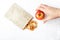 Organic homemade dry fruit chips in a paper eco pack and fresh apples on a white background. Healthy vegan snack of apples. The