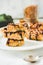 Organic homemade granola bars with date caramel and chocolate on white marble background.Selective focus.