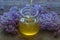 Organic honey pours in a glass jar, wrapped in a spring flower,