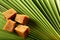 Organic jaggery cubes on palm tree leaf