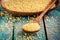 Organic millet seeds in a wooden spoon closeup