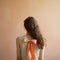 Organic Minimalism: A Captivating Image Of A Woman With An Orange Bow