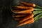 Organic Nantes Carrots on Rustic Dark Background. Fresh Superfood Healthy Eating Concept.