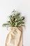 Organic olive branches in bio bag . Top view  white background. Healthy lifestyle and recycling usage