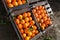 Organic oranges for sale in wooden boxes.