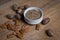 Organic pecan butter in bowl with raw pecans on a wooden table