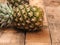 Organic pineapples on rustic wood