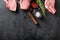 Organic Pork meat chop set over american classic butcher knife or cleaver with spices and rosemary and red pepper on black slate