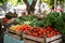 Organic produce being sold at a local market, big city buildings on background.