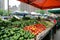 Organic produce being sold at a local market, big city buildings on background.