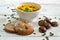 Organic pumpkin soup in a white bowl framed by chestnuts and chestnut bread and pumpkin seeds