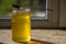 Organic pure honey in jar on window sill