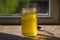 Organic pure honey in jar on window sill