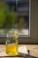 Organic pure honey in jar on window sill. Stream of honey