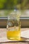 Organic pure honey in jar on window sill. Stream of honey