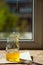 Organic pure honey in jar on window sill. Stream of honey