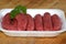 organic raw beef sausages and parsley