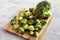 Organic Raw Broccoli Florets on a wooden board, side view