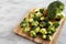 Organic Raw Broccoli Florets on a wooden board, side view. Copy space
