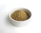 Organic raw Brown Rice in a white bowl on white background, angle view. Integral Wholegrain