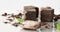 Organic raw cacao bean seed with chocolate, powder and cacao candy dessert cubes accompanied by basil green leaf