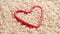 Organic raw unprocessed integral brown rice seeds in red heart shape