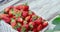 Organic ripe strawberries inside white wicker basket