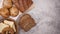 Organic rye bread, toast bread, buns and bagel with sesame appear on left side - Stop motion